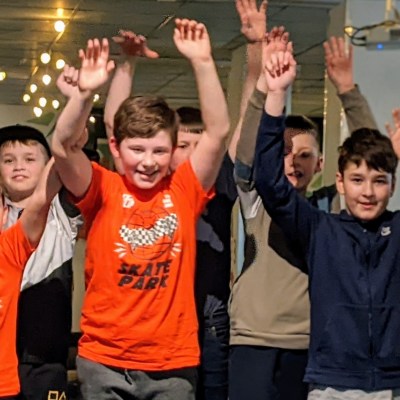 kids with arms in air