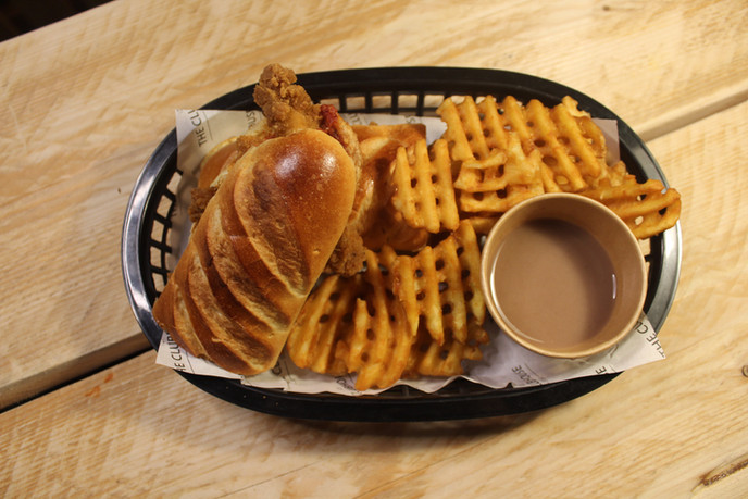 a plate of food sitting on top of a wooden table