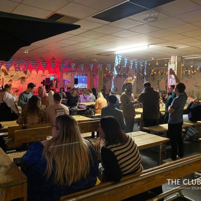 a group of people standing around a table