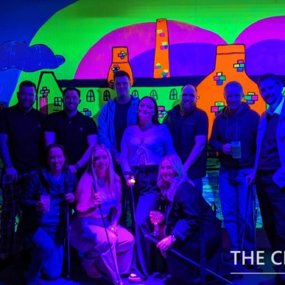 a group of people standing in front of a stage