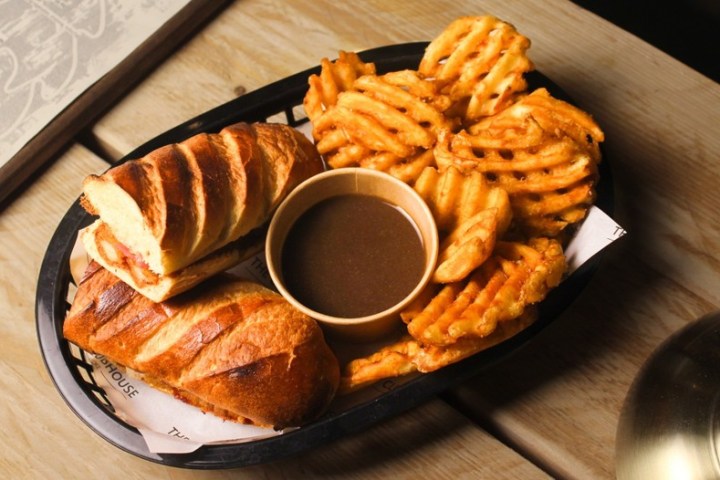 a plate of food sitting on top of a wooden table