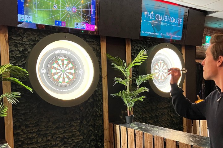 a man playing darts