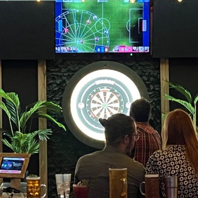 a group of people standing in front of a computer