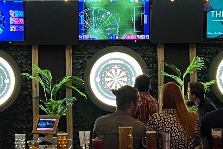 a group of people standing in front of a computer