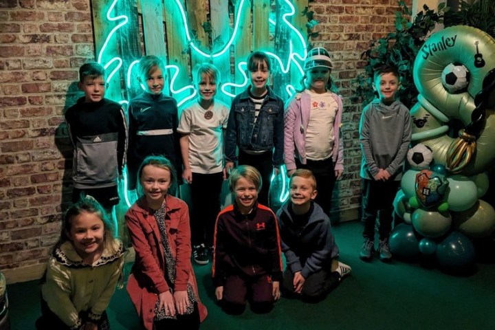 a group of people posing for a photo in front of a building