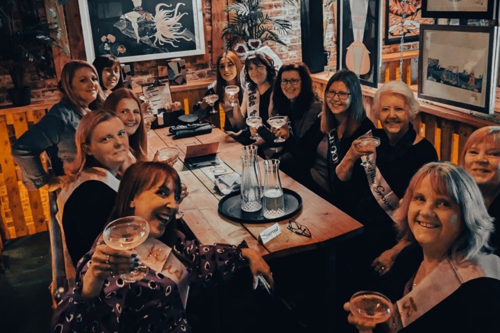 a group of people sitting at a table posing for the camera