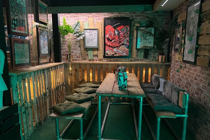 a green chair in front of a store