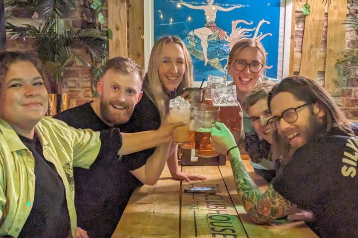 a group of people sitting at a table posing for the camera
