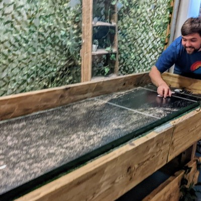 a man sitting on top of a wooden ramp