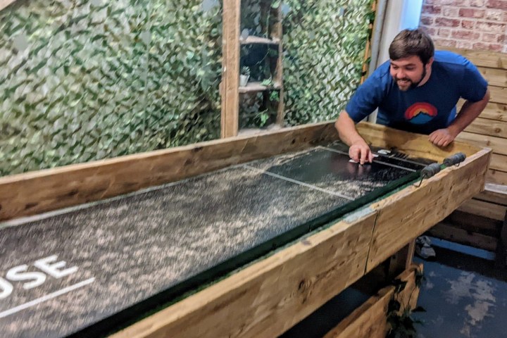 a man sitting on top of a wooden ramp