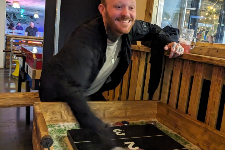 man playing shuffleboard