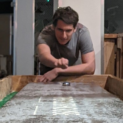 a man sitting in front of a building