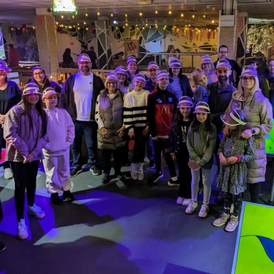 a group of people standing in front of a crowd posing for the camera