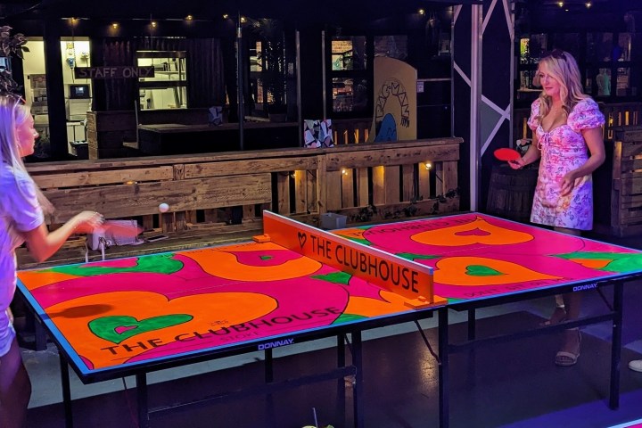 a person standing in front of a cake