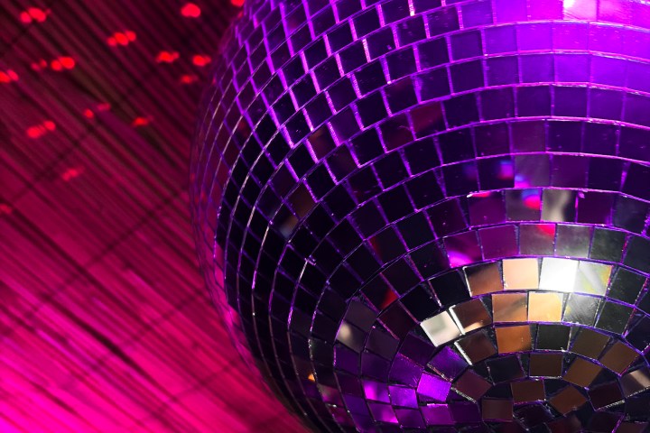 Pavilion Cocktail Bars Purple disco ball reflecting light with pink and red background.